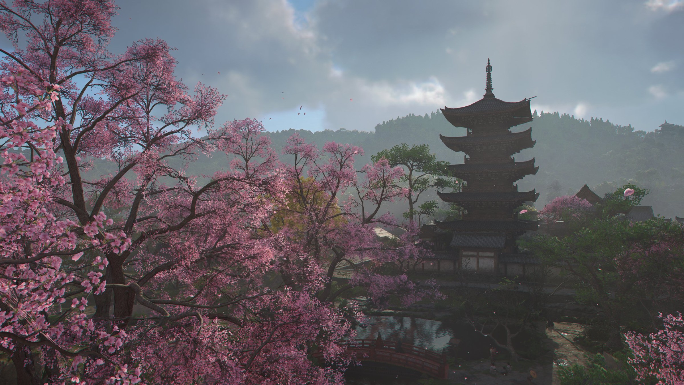 A look at a cherry tree blooming with a tall temple in the darkness of Assassin