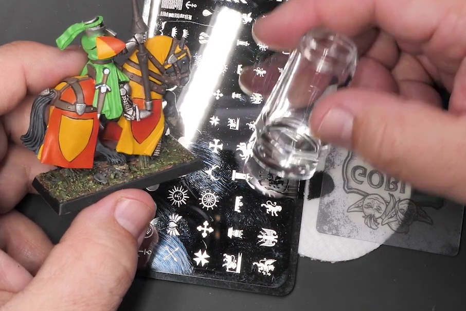 A clear plastic silicon stamp is used to raise images from a metal plate.